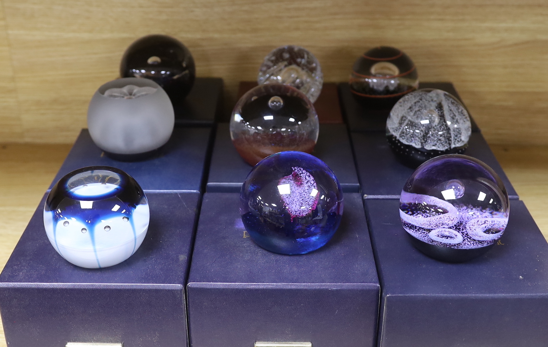 Nine Caithness paperweights including Ice Blossom, limited edition 419/1000 and Touchdown, 361/1000, each with boxes, the largest 7.5cm high